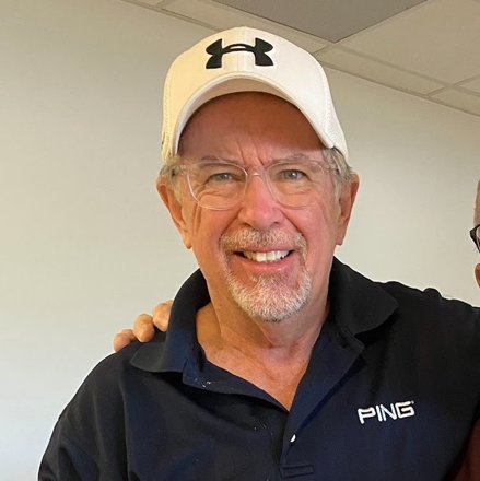 Don May, smiling, wearing a white cap